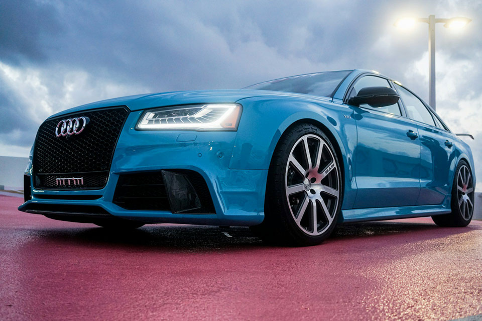 blue audi sedan with headlight on